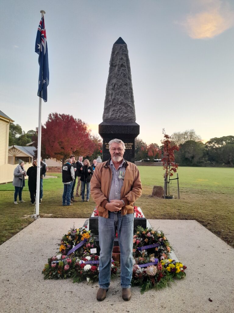 man standing in front of cenotaph